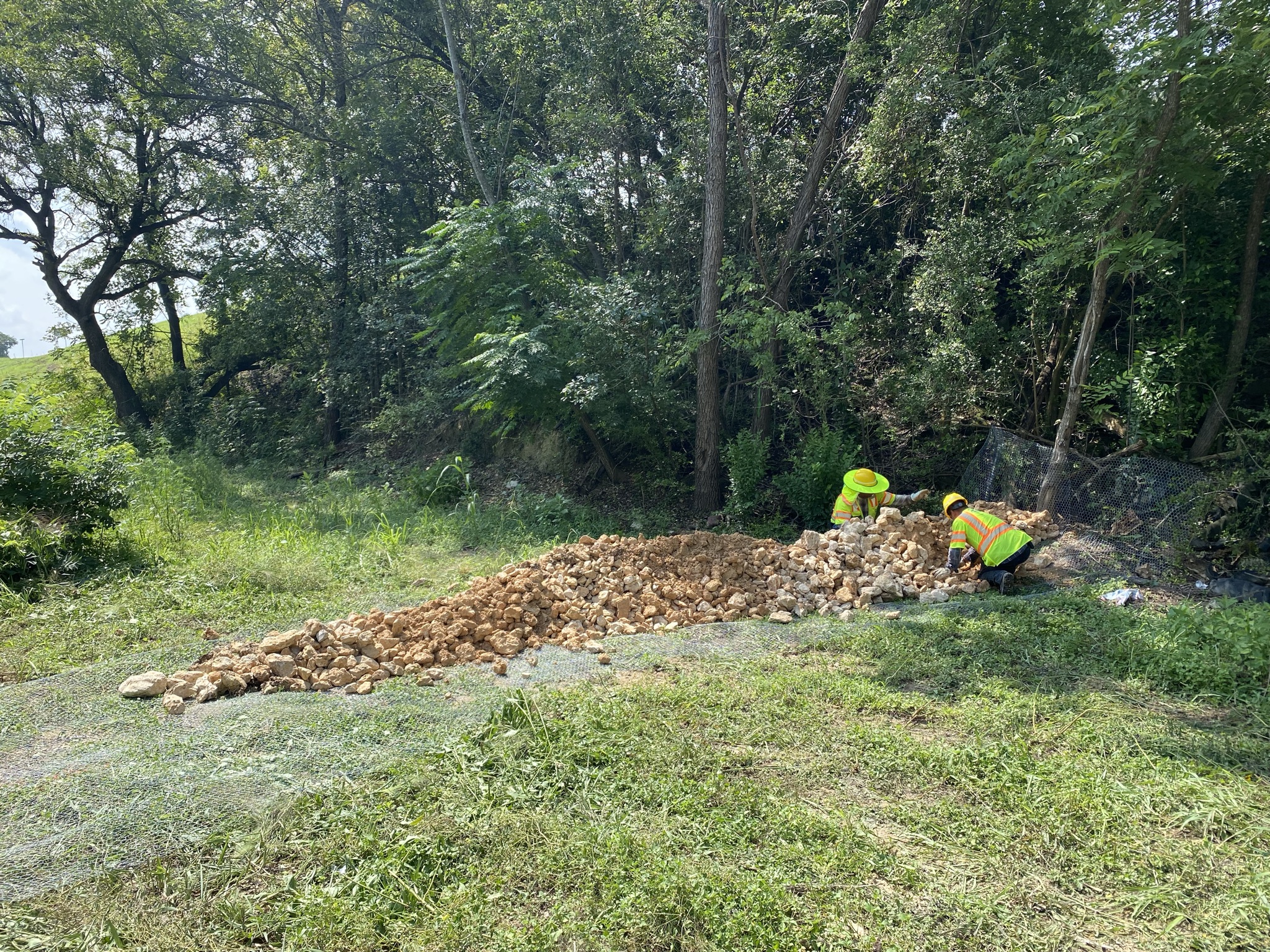 Crews install a rock filter dam for erosion control to protect water resources, August 2021